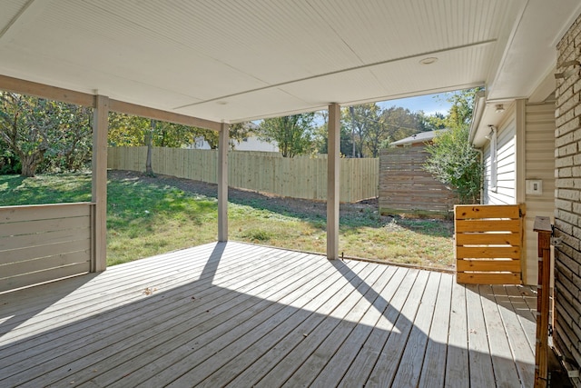 wooden terrace featuring a yard