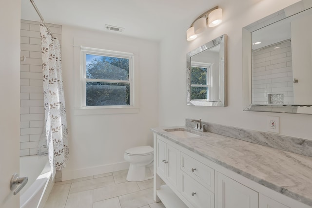 full bathroom with vanity, toilet, a healthy amount of sunlight, and shower / bath combo