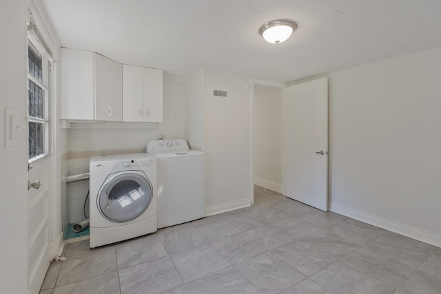 laundry room featuring cabinets and washing machine and clothes dryer