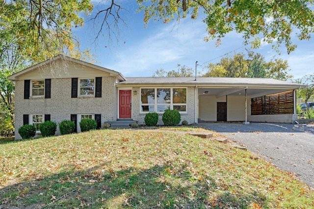 tri-level home with a front yard and a carport