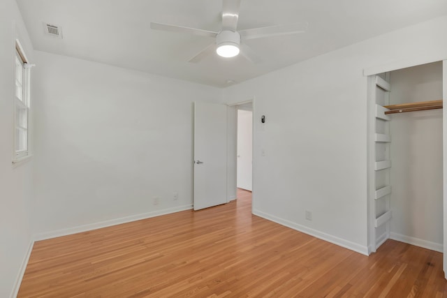 unfurnished bedroom with a closet, light wood-type flooring, and ceiling fan