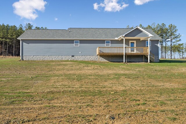 back of property featuring a deck and a yard