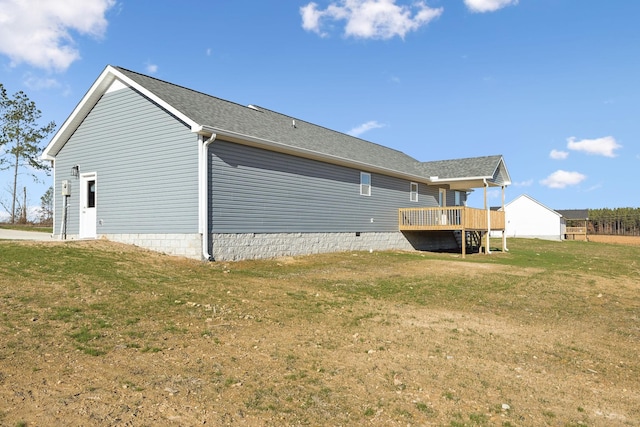 back of house featuring a yard and a deck