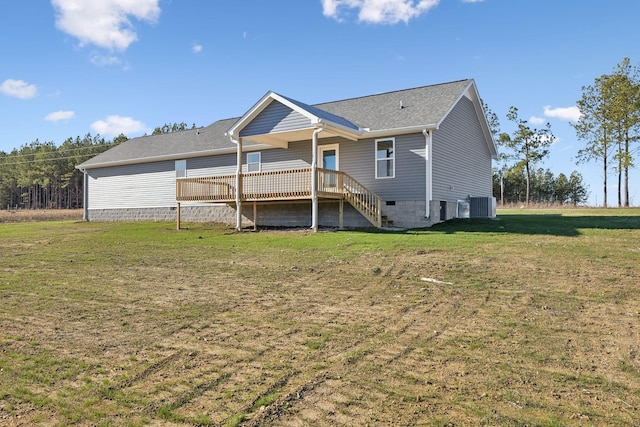 rear view of property featuring a yard, central AC unit, and a wooden deck