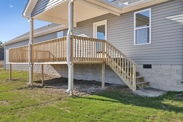 view of side of home featuring a yard and a deck