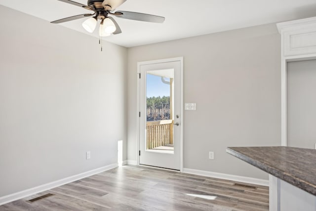 interior space with ceiling fan and light hardwood / wood-style flooring