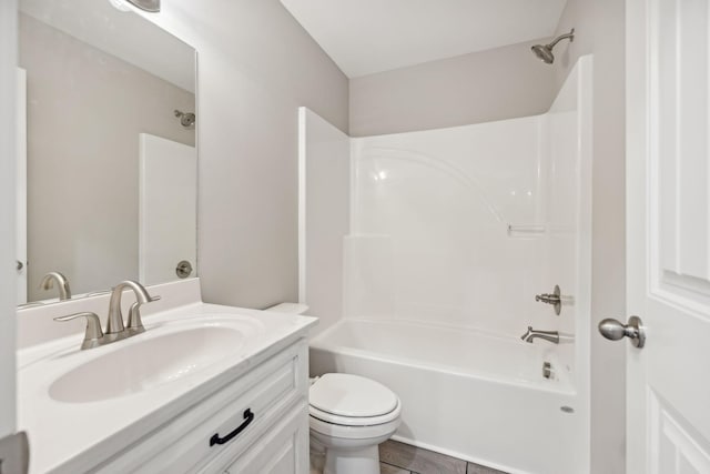 full bathroom with tile patterned flooring, vanity,  shower combination, and toilet