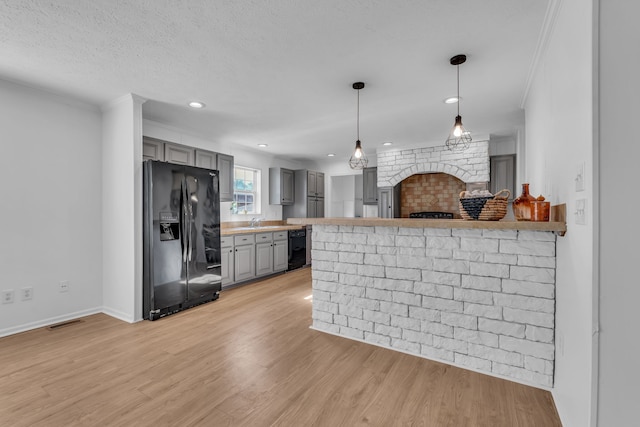 kitchen with kitchen peninsula, gray cabinetry, light wood-type flooring, and black fridge with ice dispenser