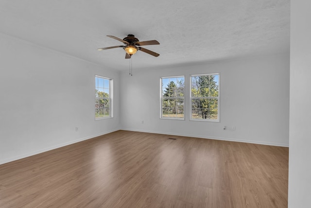 spare room featuring a textured ceiling, light hardwood / wood-style floors, and ceiling fan