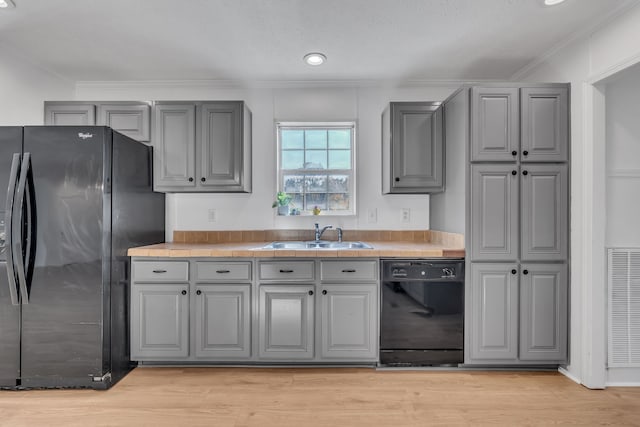 kitchen with black appliances, sink, light hardwood / wood-style floors, and gray cabinets