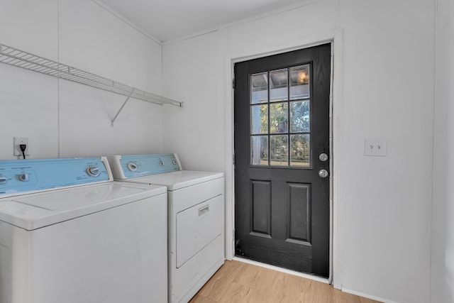 washroom with washer and dryer and light hardwood / wood-style flooring