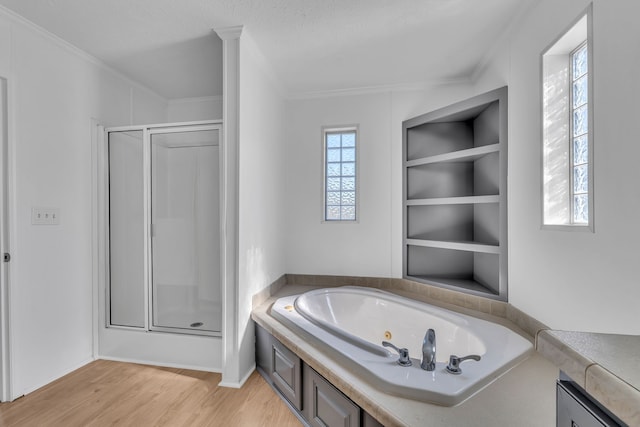 bathroom featuring built in features, shower with separate bathtub, wood-type flooring, and crown molding