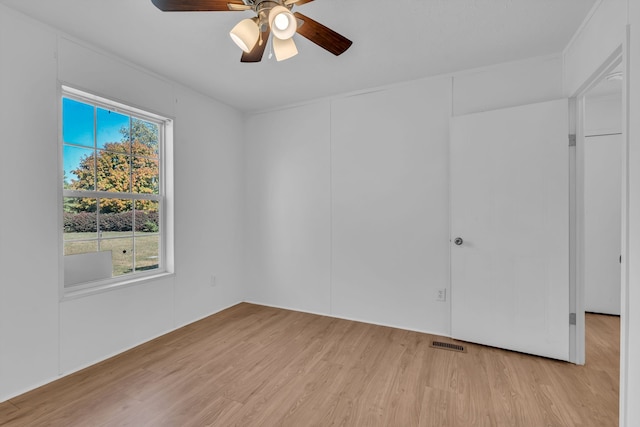 spare room with light hardwood / wood-style floors and ceiling fan