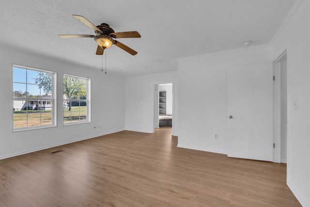 interior space with crown molding, ceiling fan, and light hardwood / wood-style flooring