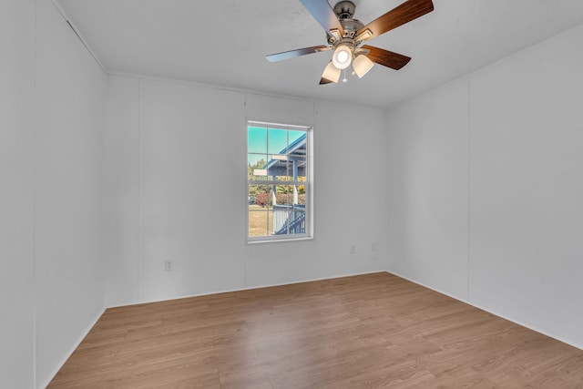 unfurnished room featuring light wood-type flooring and ceiling fan