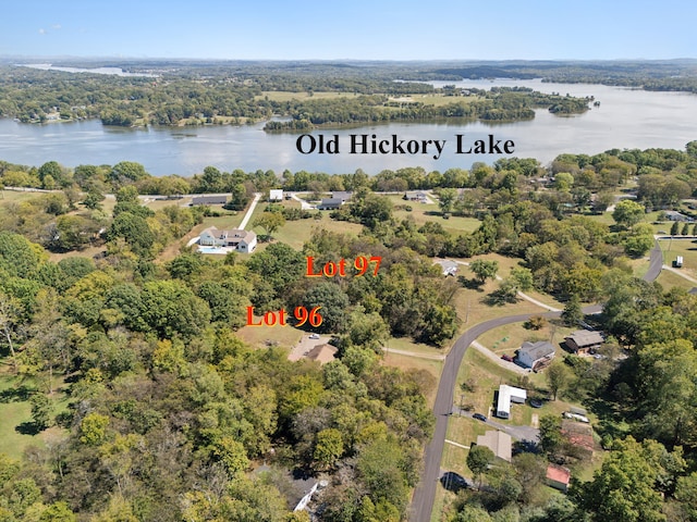 aerial view featuring a water view and a wooded view