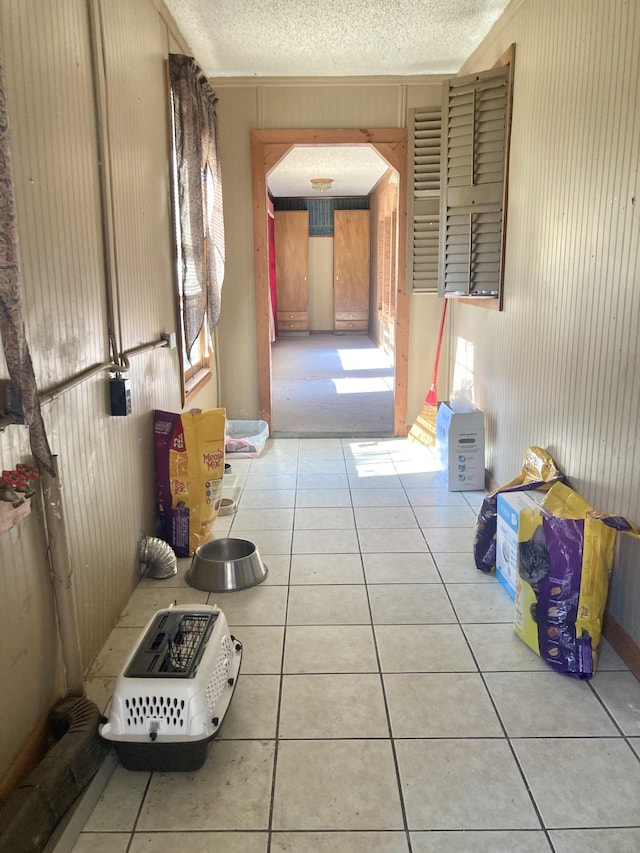 hall featuring light tile patterned floors