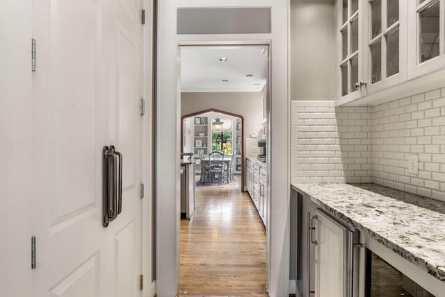 2304 Valley Brook Rd, Nashville, TN 37215 - interior space with decorative backsplash, ornamental molding, light stone countertops, and light wood finished floors