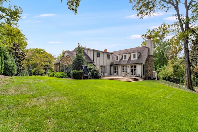 rear view of property with a yard and french doors