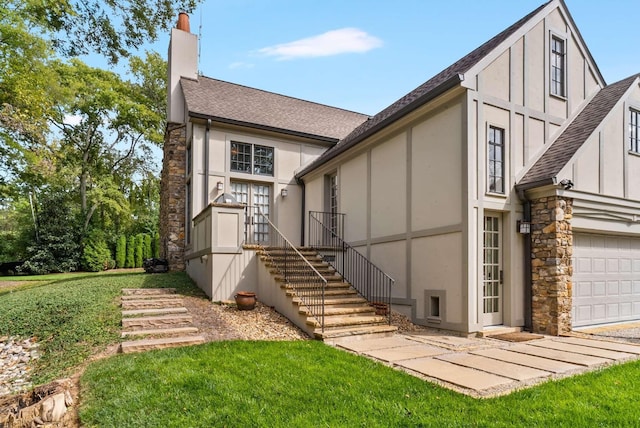 2304 Valley Brook Rd, Nashville, TN 37215 - back of property with a shingled roof, stone siding, stucco siding, a chimney, and a lawn