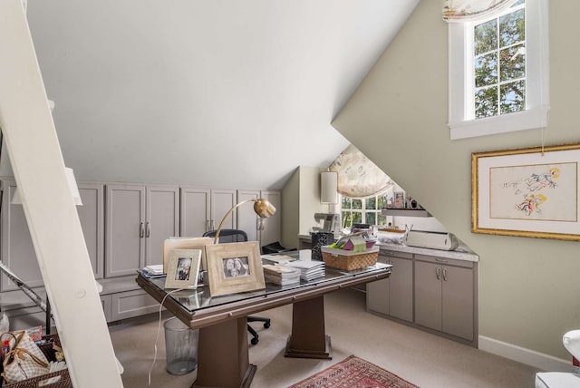 carpeted home office featuring vaulted ceiling and a wealth of natural light