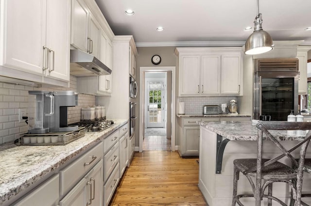 2304 Valley Brook Rd, Nashville, TN 37215 - kitchen with beverage cooler, a kitchen bar, under cabinet range hood, tasteful backsplash, and appliances with stainless steel finishes