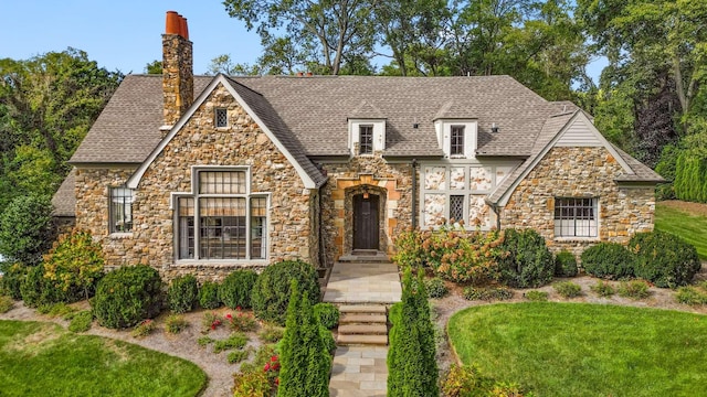 2304 Valley Brook Rd, Nashville, TN 37215 - tudor home with a chimney, a front lawn, roof with shingles, and stone siding
