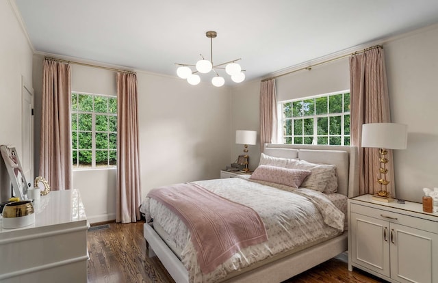 bedroom with multiple windows, ornamental molding, dark hardwood / wood-style flooring, and a chandelier