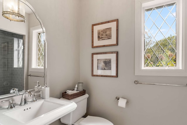 bathroom with sink, a healthy amount of sunlight, and toilet