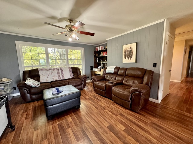 living room with ceiling fan, hardwood / wood-style flooring, and crown molding