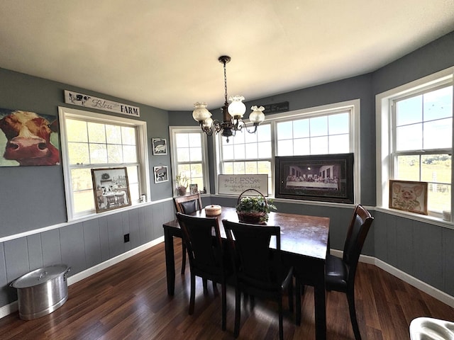 dining area featuring a chandelier and dark wood-type flooring