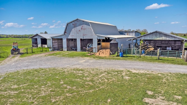 view of front facade featuring a rural view and an outbuilding