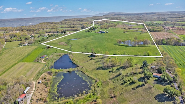 drone / aerial view featuring a water view and a rural view