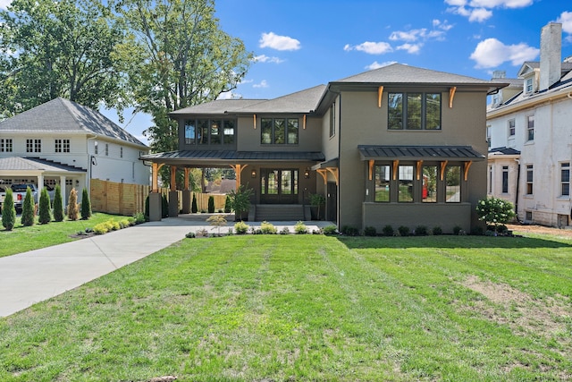 view of front of home with a front yard and a carport