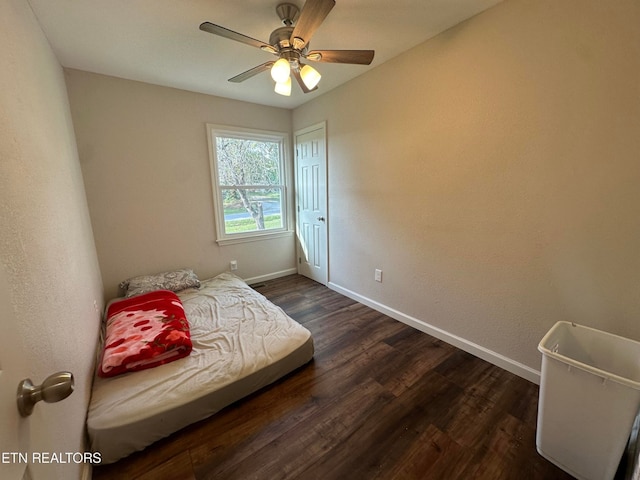 bedroom with dark hardwood / wood-style floors and ceiling fan