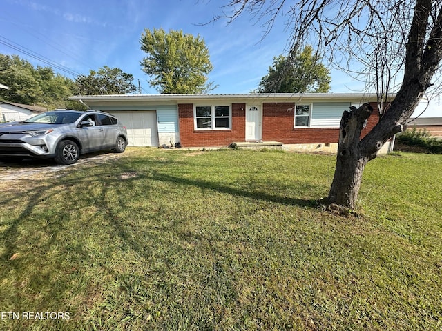 view of front of property with a front lawn and a garage