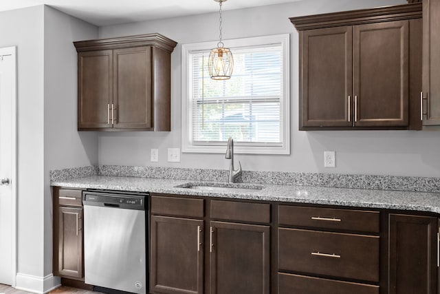 kitchen featuring light stone countertops, dark brown cabinetry, stainless steel dishwasher, sink, and a chandelier