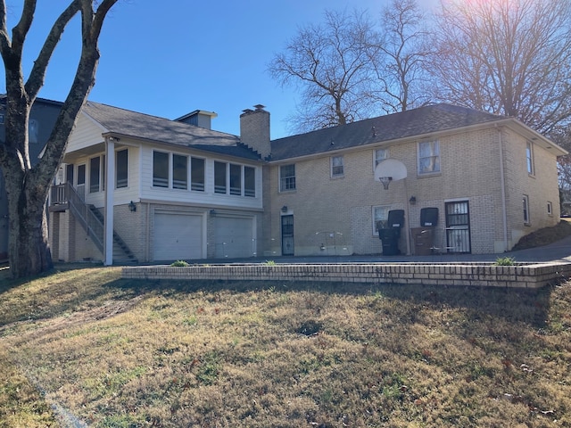 back of property featuring a yard and a garage