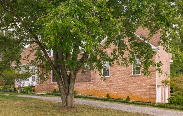 view of home's exterior with a yard and a garage