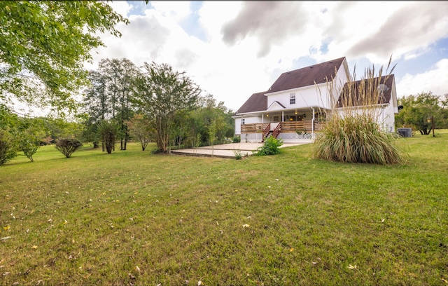 view of yard featuring a wooden deck and a patio area