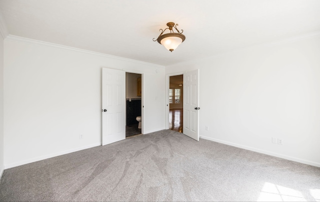 empty room with carpet and crown molding