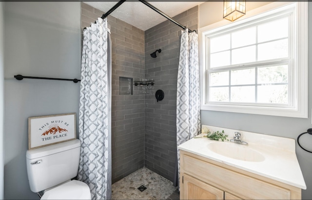 bathroom featuring a shower with shower curtain, plenty of natural light, vanity, and toilet