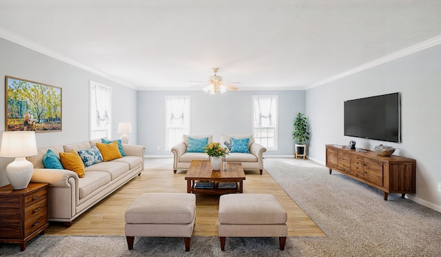 living room with ceiling fan, light colored carpet, and crown molding