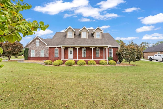 cape cod house with a front lawn and covered porch