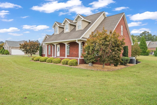 exterior space with a lawn, a garage, central AC unit, and covered porch