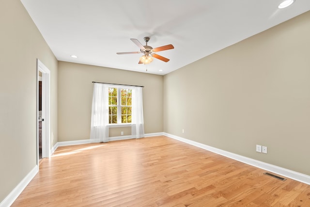 empty room with light hardwood / wood-style floors and ceiling fan