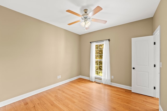 empty room with light hardwood / wood-style floors and ceiling fan