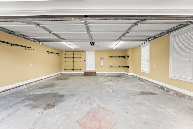 garage featuring a garage door opener and electric panel