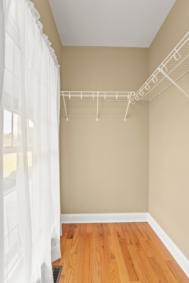 spacious closet with hardwood / wood-style floors