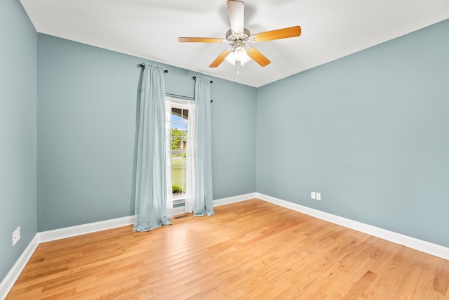 unfurnished room with ceiling fan and hardwood / wood-style flooring